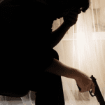 Foto van depressieve man met pistool in hand