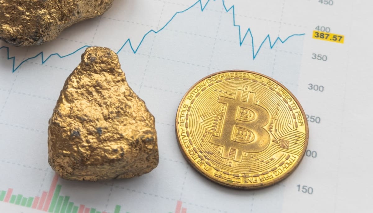 Een goudklomp en een bitcoin munt naast elkaar met een grafiek op de achtergrond