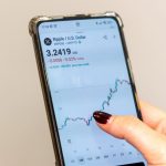 Een afbeelding van een handelaar die naar de XRP cryptopagina met koers kijkt