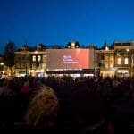 Een afbeelding van World Cinema Amsterdam op een groot plein met veel mensen in Nederland