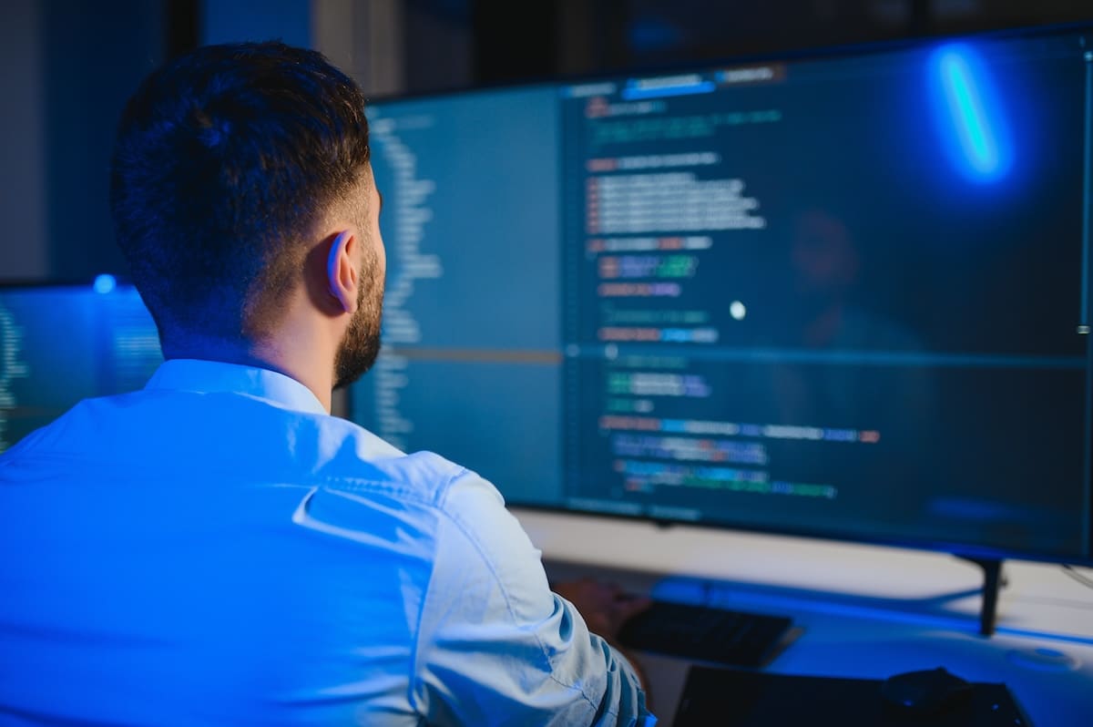 Programmeur kijkt naar scherm met code